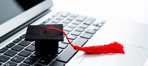Graduation hat on computer keyboard